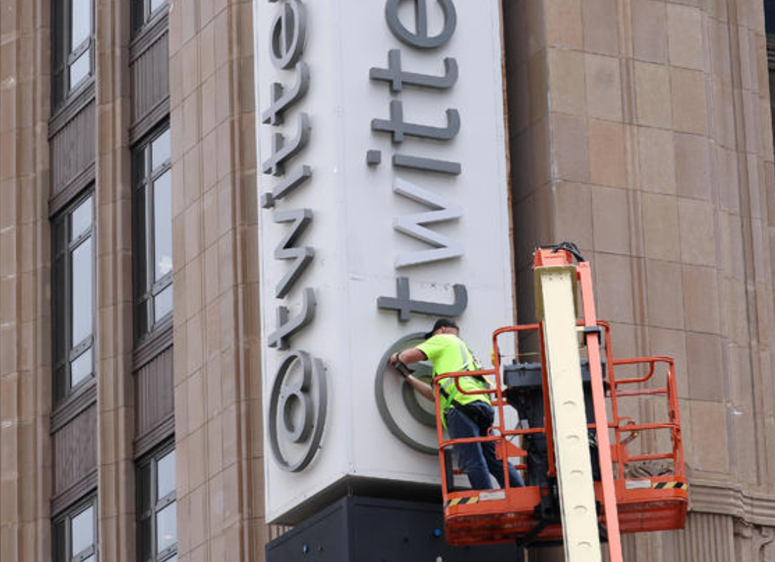 A worker removes letters from the Twitter sign that is posted on the exterior of Twitter headquarters on July 24, 2023, in San Francisco, California. 